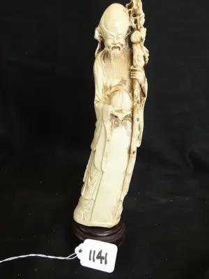 OLD IVORY MAN HOLDING STAFF - ROUND WOOD STAND -