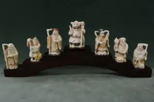 7 Japanese ivory carved netsuke on stand