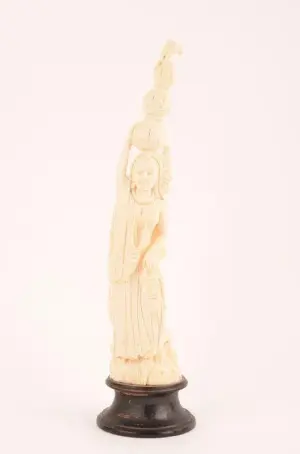 Finely carved ivory figure of a lady balancing baskets.