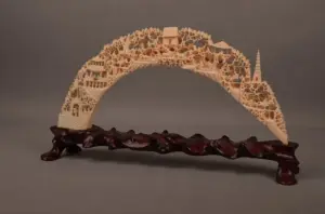 Carved ivory bridge with a well carved village with