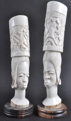 A PAIR OF WHITE IVORY AFRICAN TUSK VASES as female