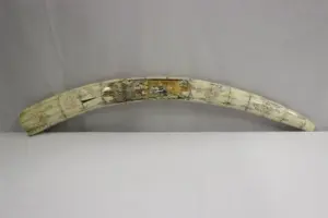 A large bone carved tusk with dragon motif