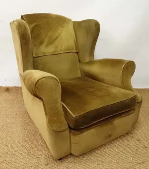 An early - mid 20thC wingback upholstered armchair with