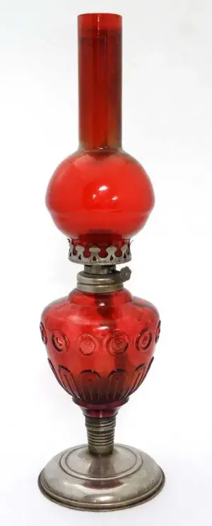 A ruby glass oil lamp with chimney and reservoir 16