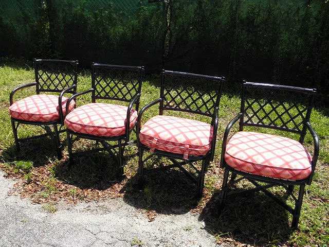 FOUR BLACK PAINTED RATTAN ARMCHAIRS