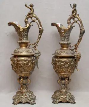 Pair of bronze oversized urns with putti motif su