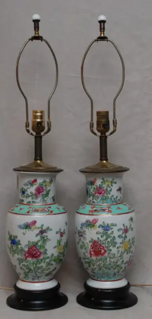 Pair of porcelain lamps on attached wood stands,