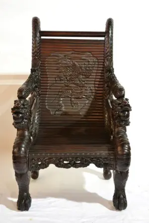 HEAVILY CARVED ORIENTAL ARM CHAIR WITH SERPENTS