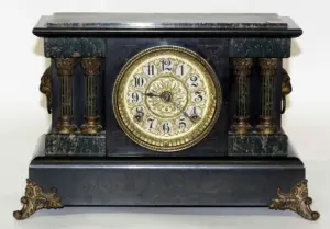 A Seth Thomas Ebonized and Faux Marble Mantel Clock,